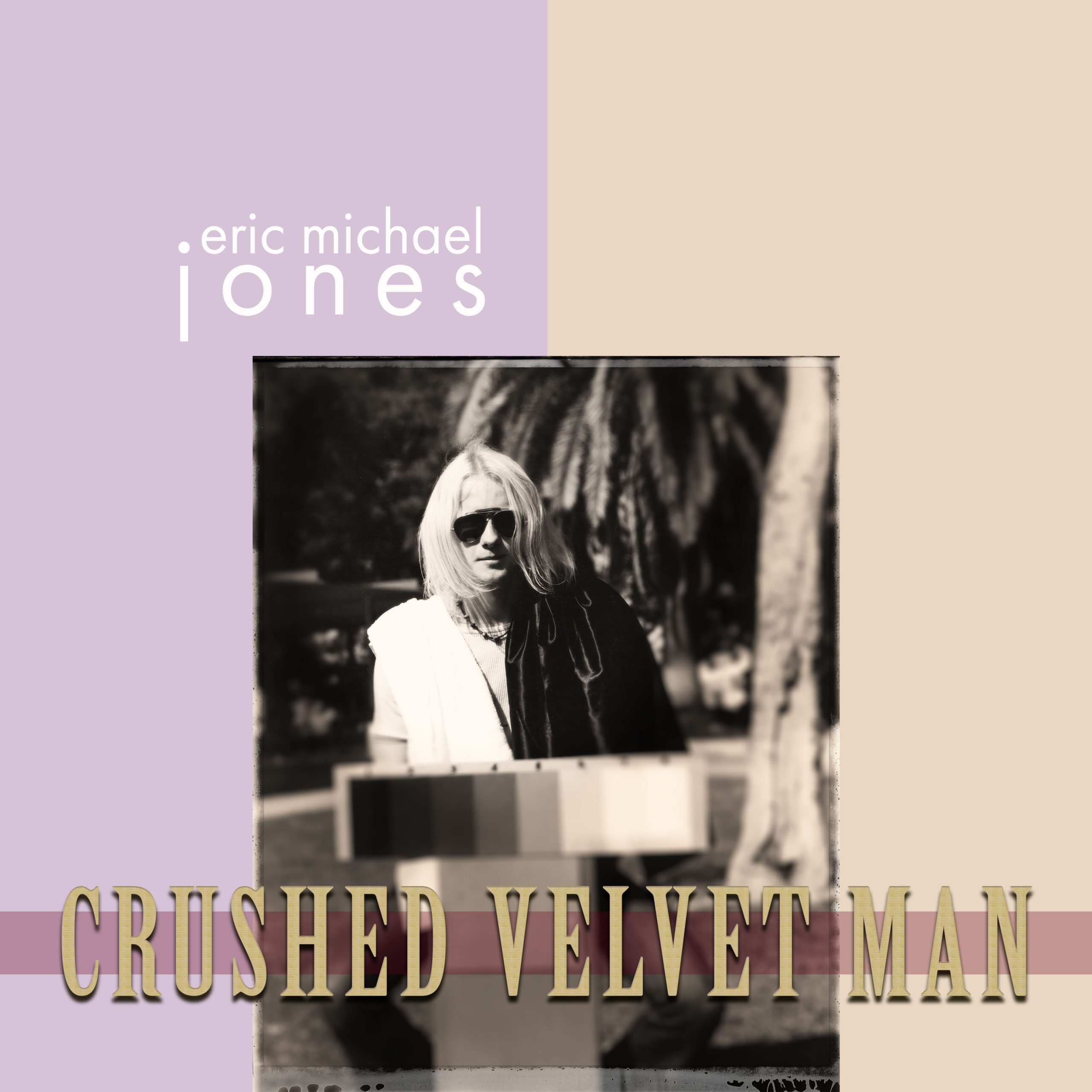 Cover art for Crushed Velvet Man shows Eric Michael Jones in sunglasses sitting in a park